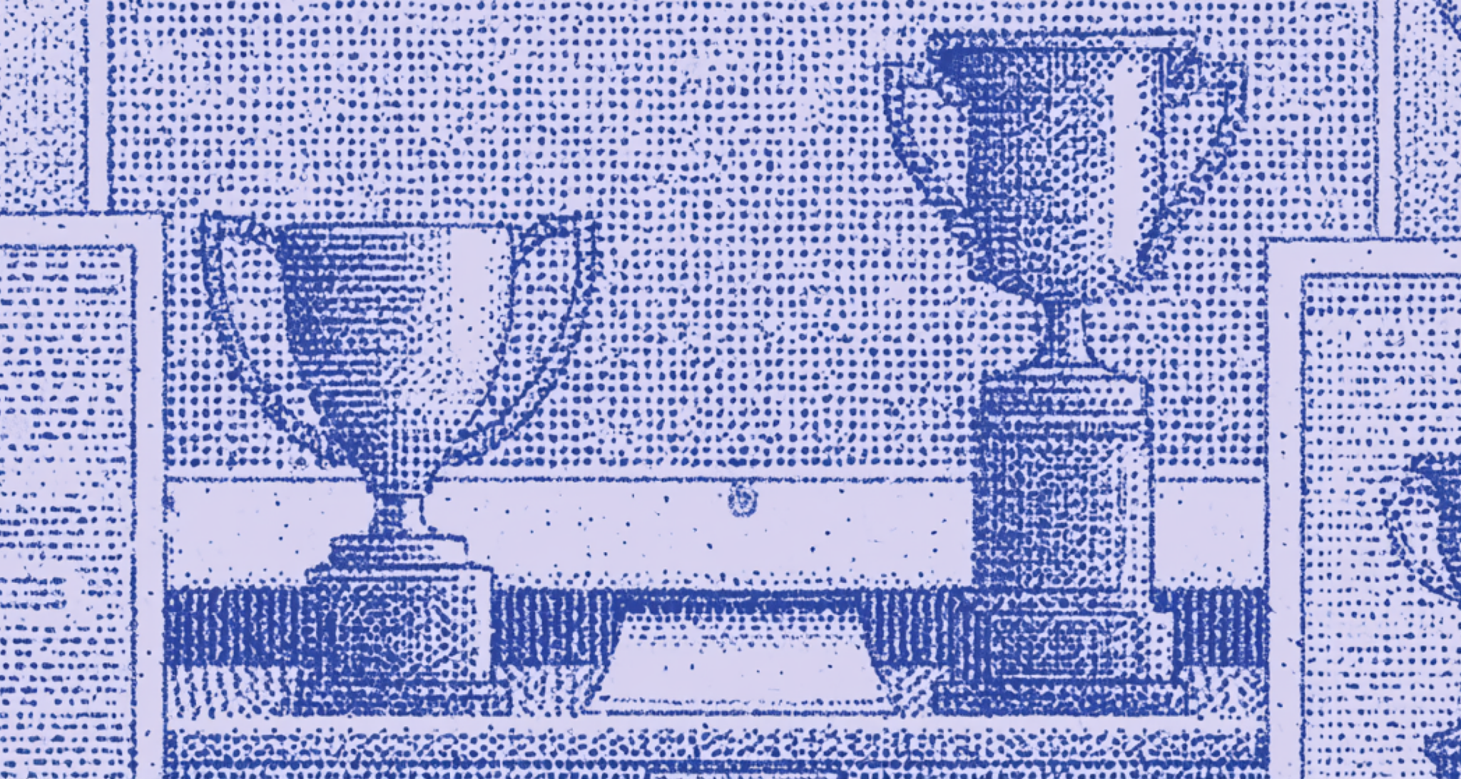 Trophy awards displayed on a shelf in front of a computer monitor.
